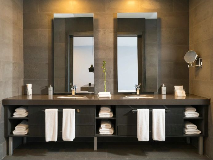 Modern bathroom remodel with dual vanity and neatly arranged towels